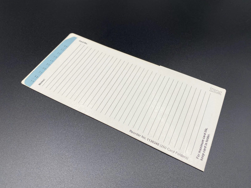 The card folder on a flat surface with a Blue IBM Ziffernkarte No 5 fully inserted.