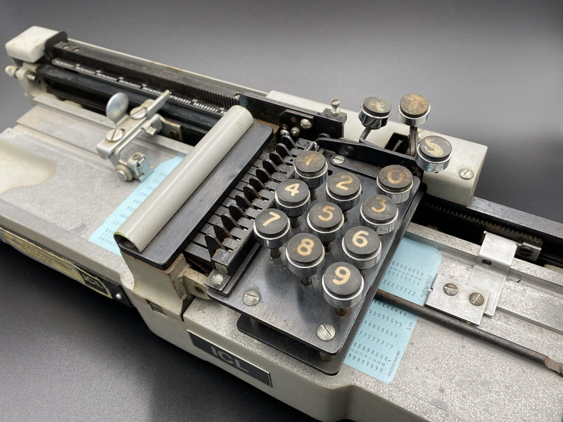 Detail of the card punch showing an 80 column card loaded into the carriage position to punch column 28.