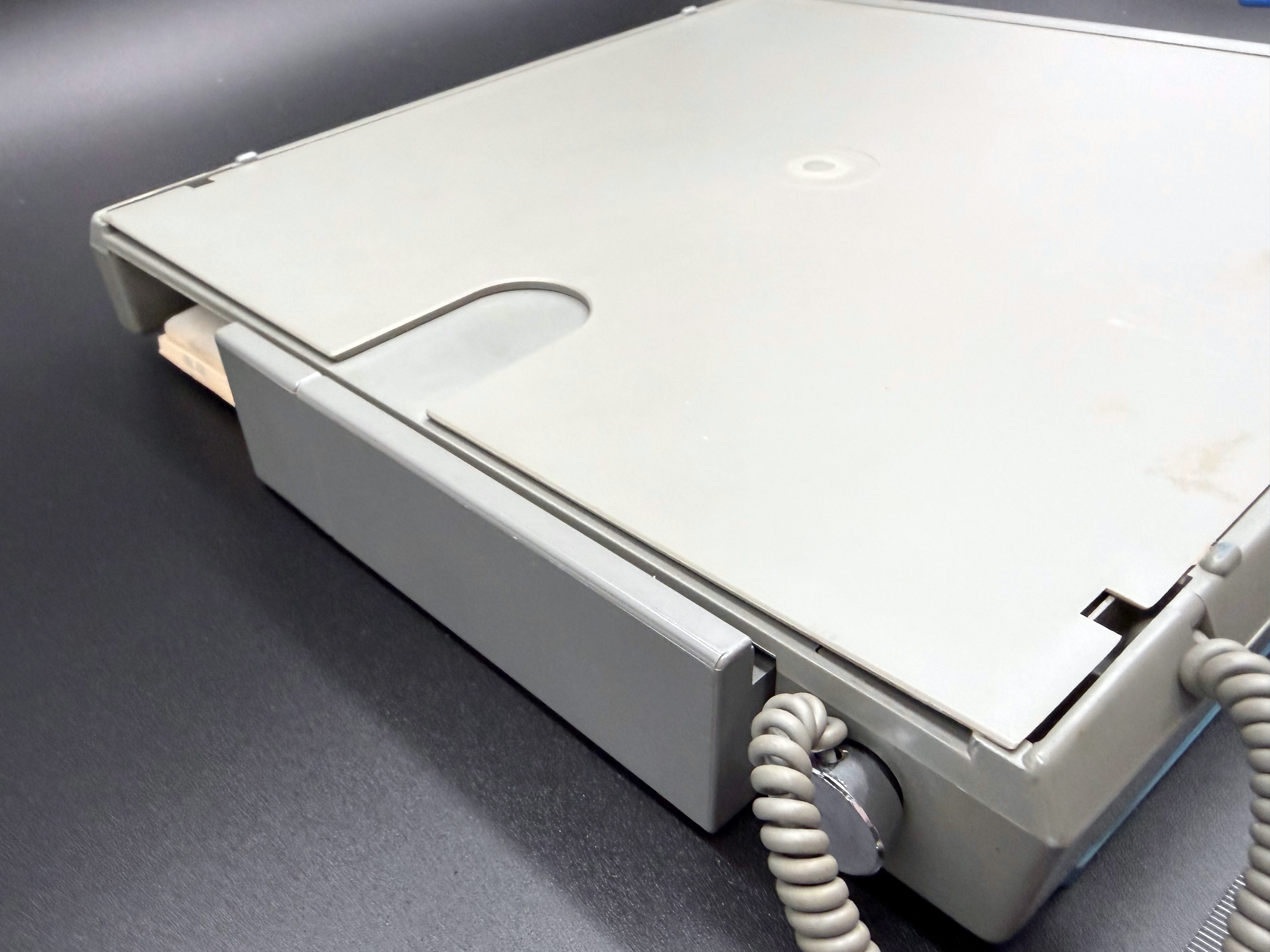 Detail of the back of the unit showing the storage compartment for additional templates or documents.