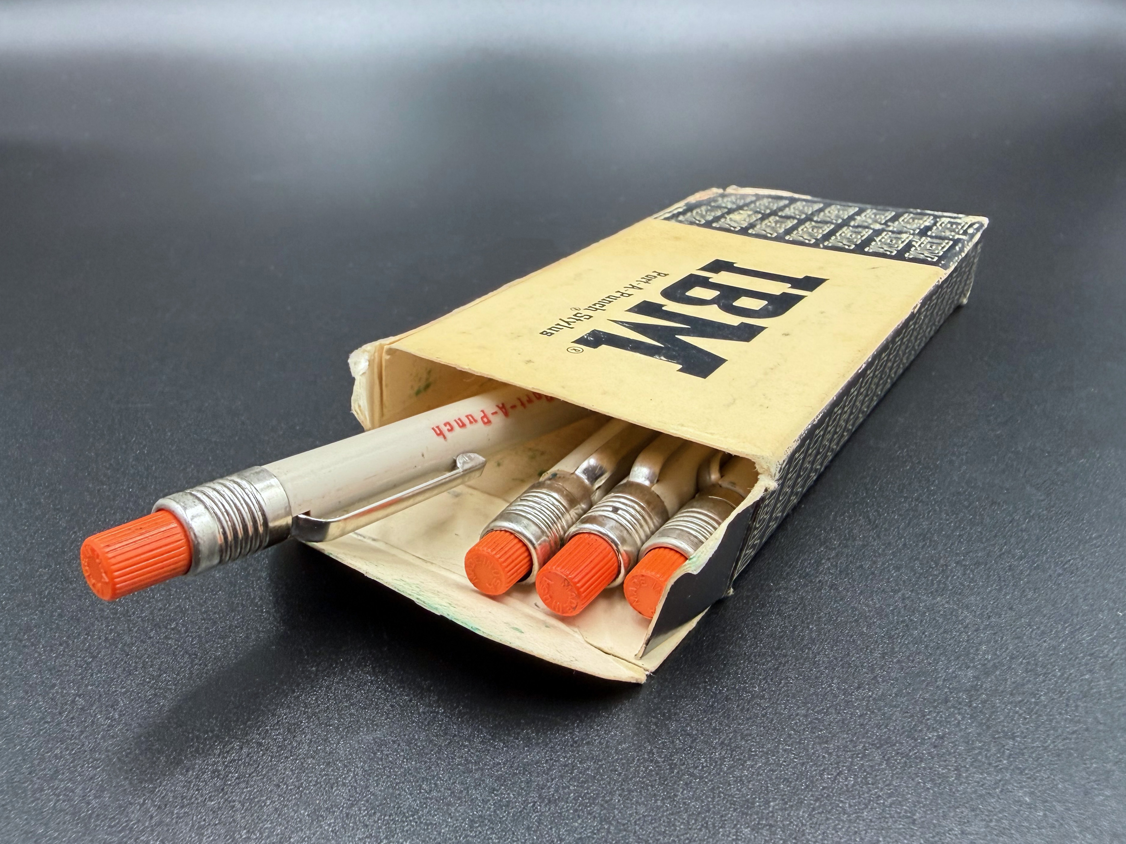 Opened box of IBM Port-a-Punch Styluses showing four styluses inside.
