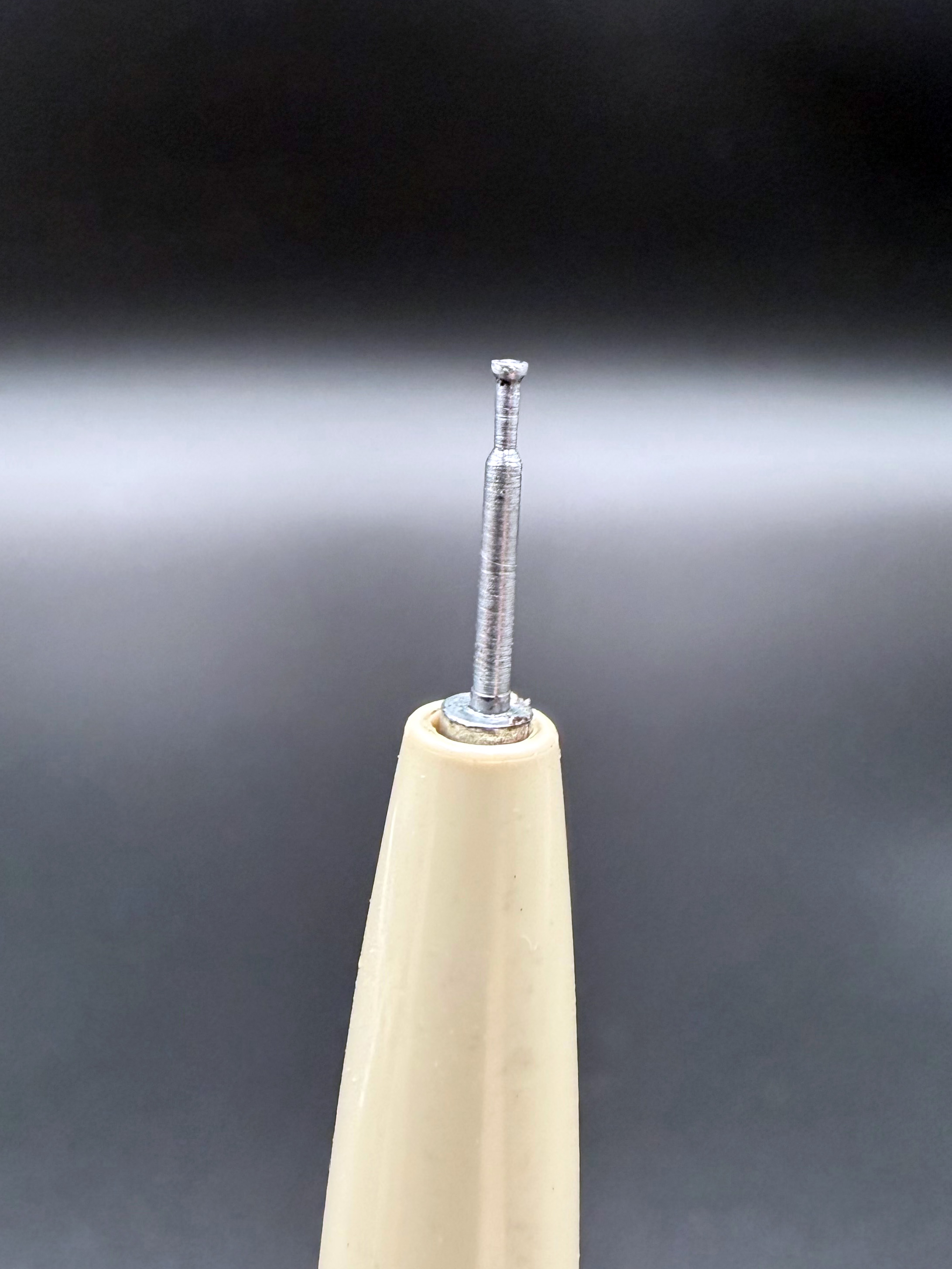 Macro detail view of the IBM Port-a-Punch Stylus punch tip when fully extended.