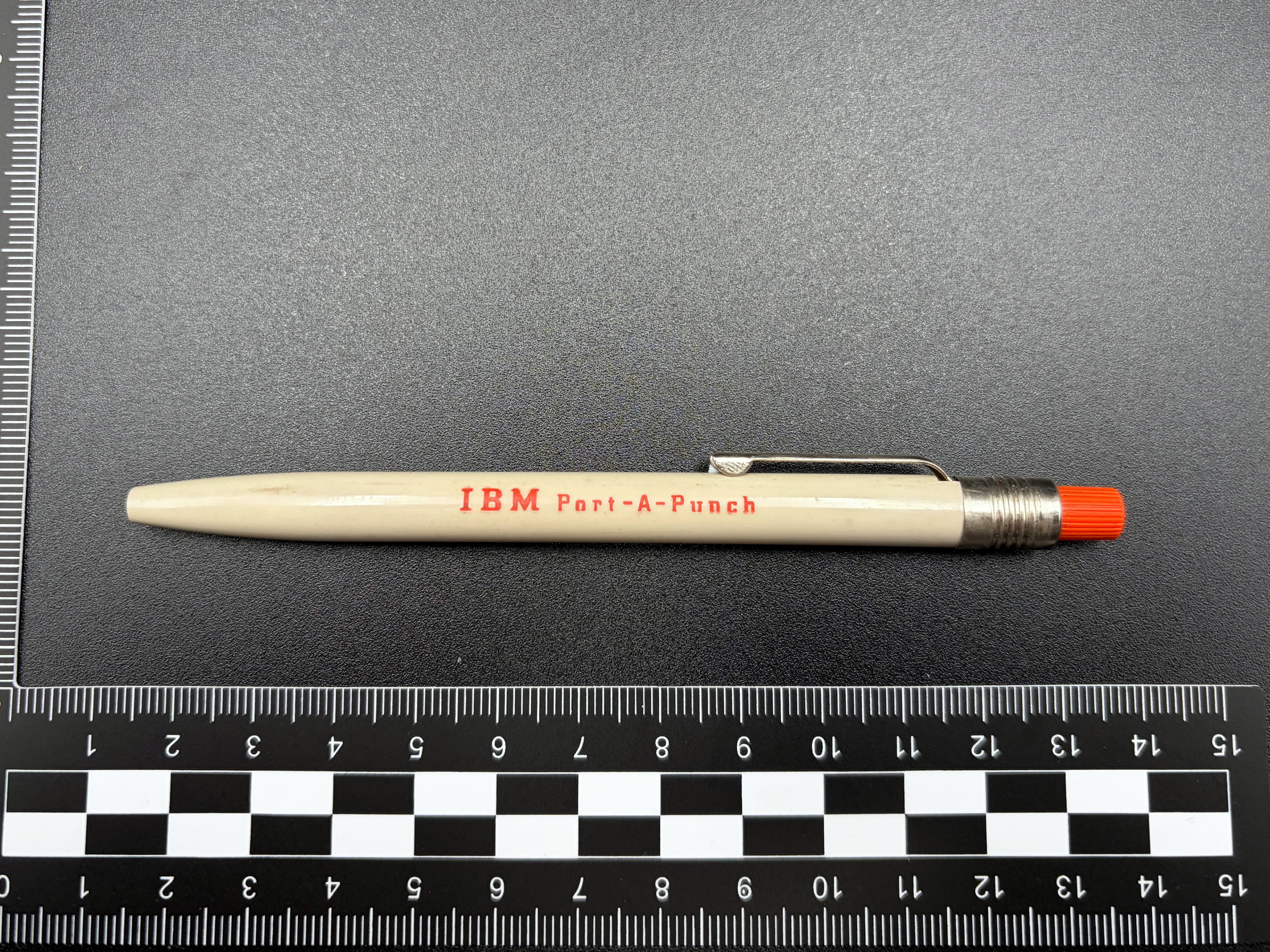 IBM Port-a-Punch Stylus shown next to a scale ruler.
