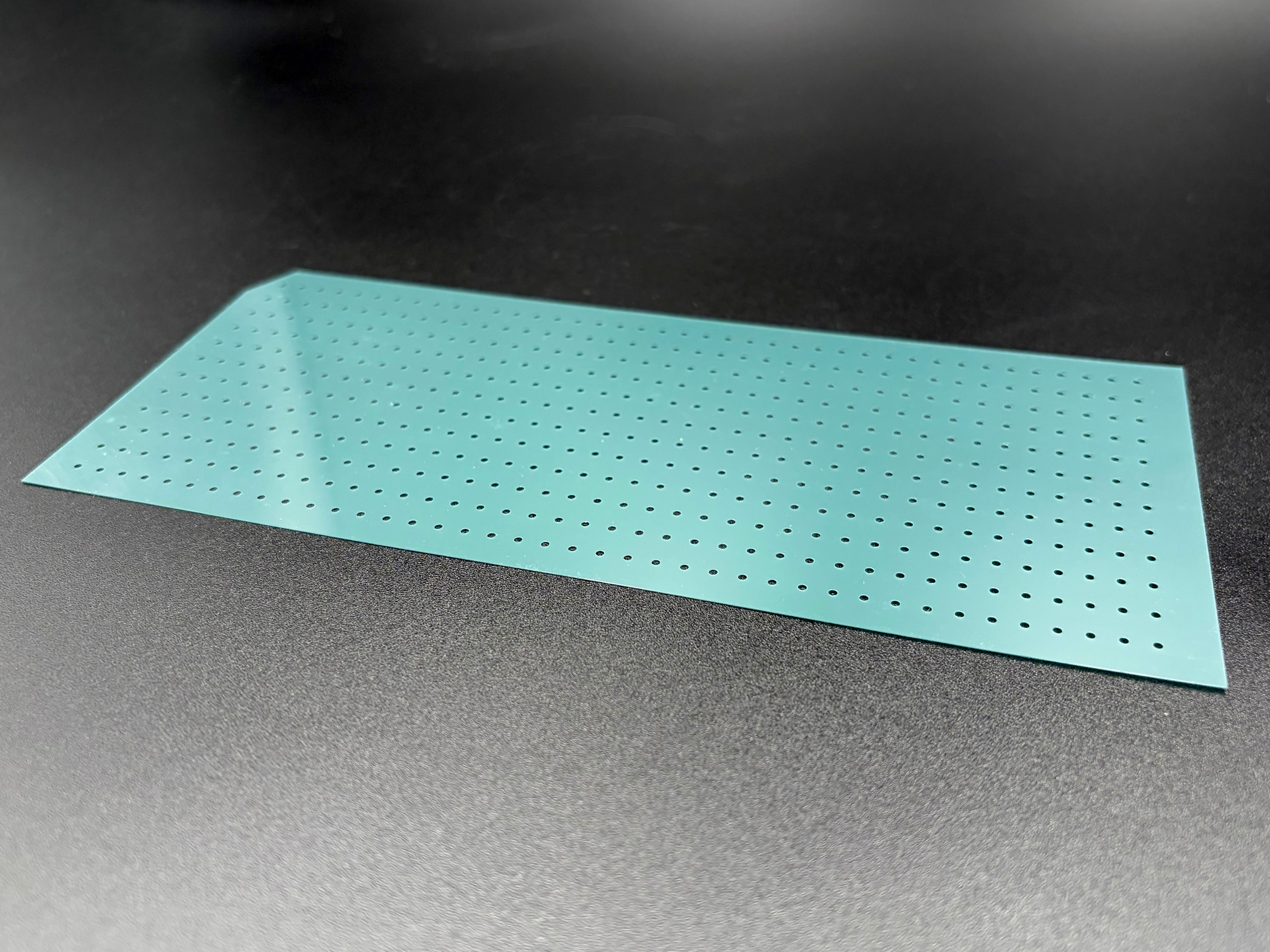 A lone punching template from the envelope, shown flat on a surface.